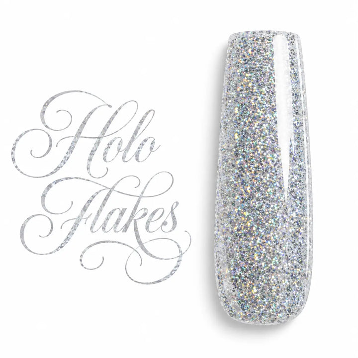 Capsule d’ongle ballerine Holo Flakes, gel UV LED argenté holographique aux éclats multicolores, finition ultra brillante sur fond blanc.